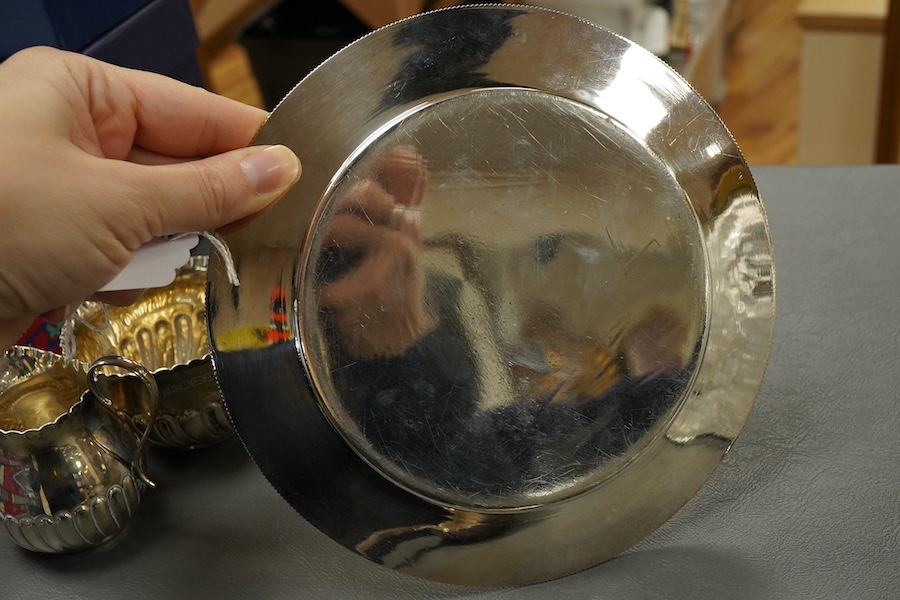 A Victorian silver side plate or stand, by John Edward Bingham (Walker & Hall), Sheffield, 1885, diameter 17.9cm, together with an early 20th century silver cream jug and sugar bowl by Barker Brothers and a Victorian pro